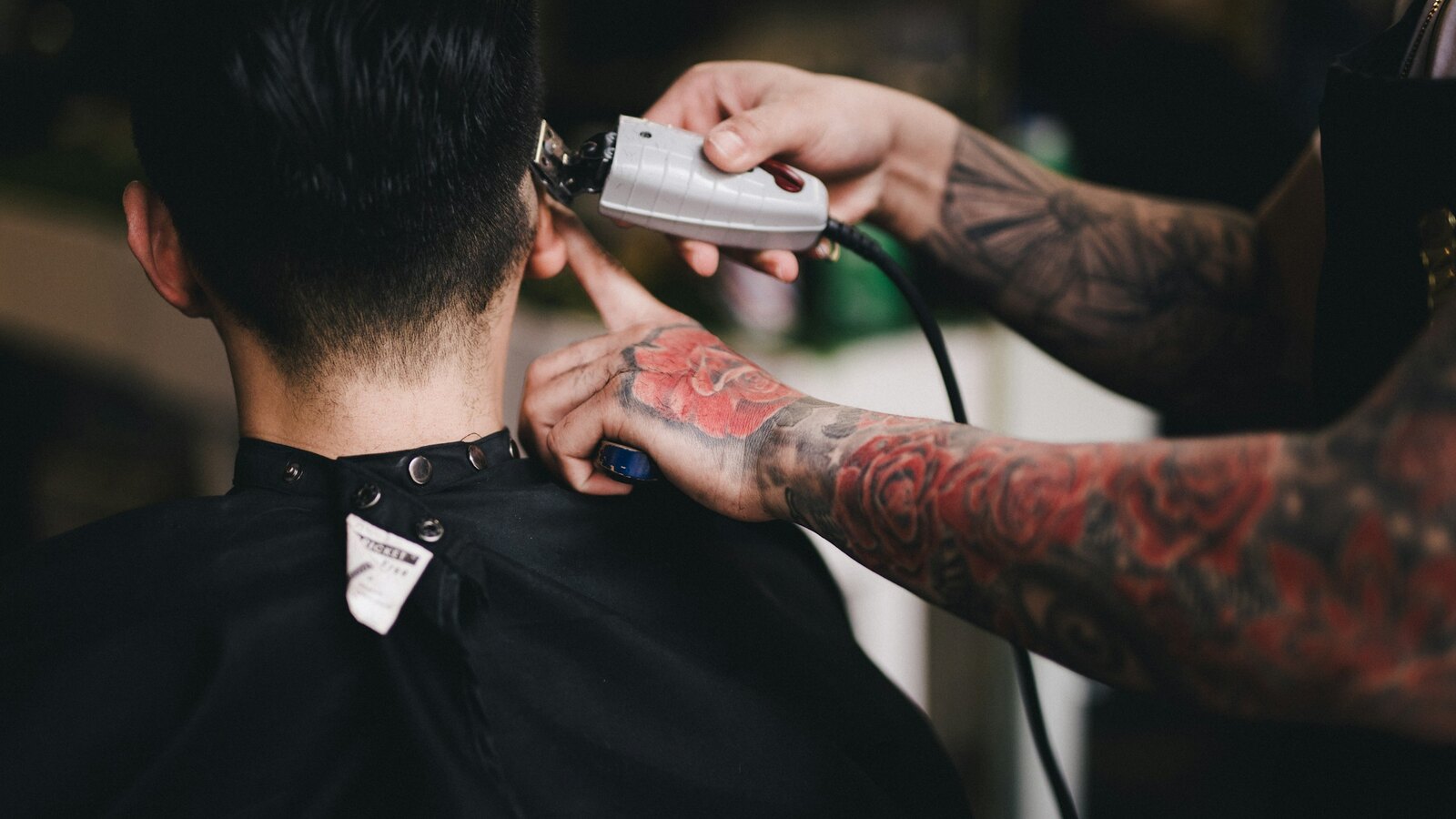 Close view of a barbers hands working clippers
