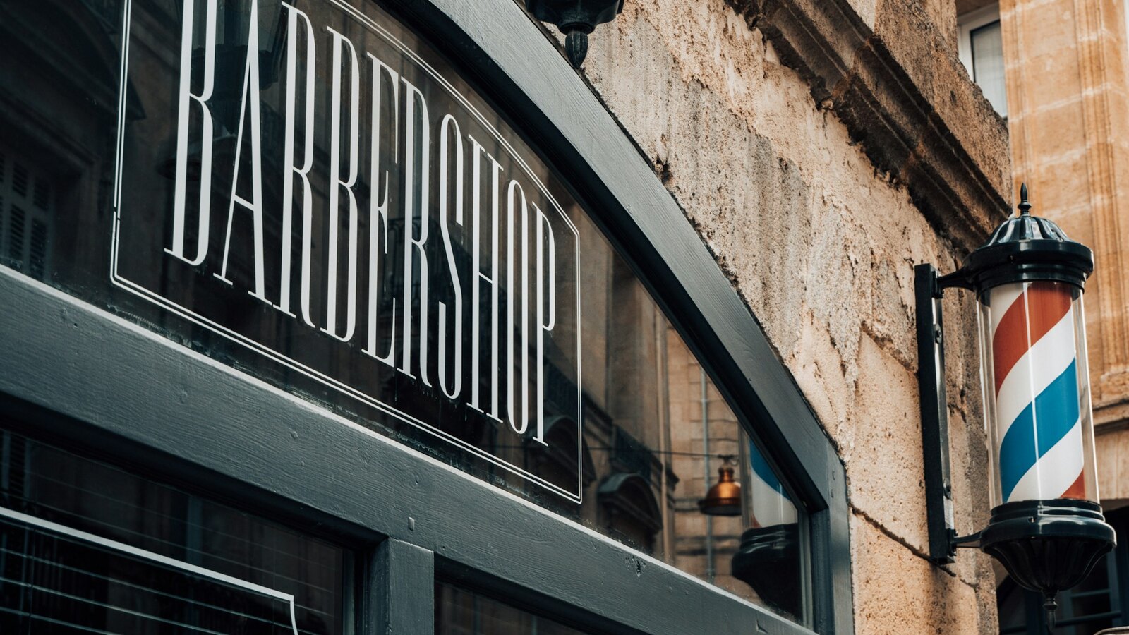 Fade and Steel barbershop window in the evening